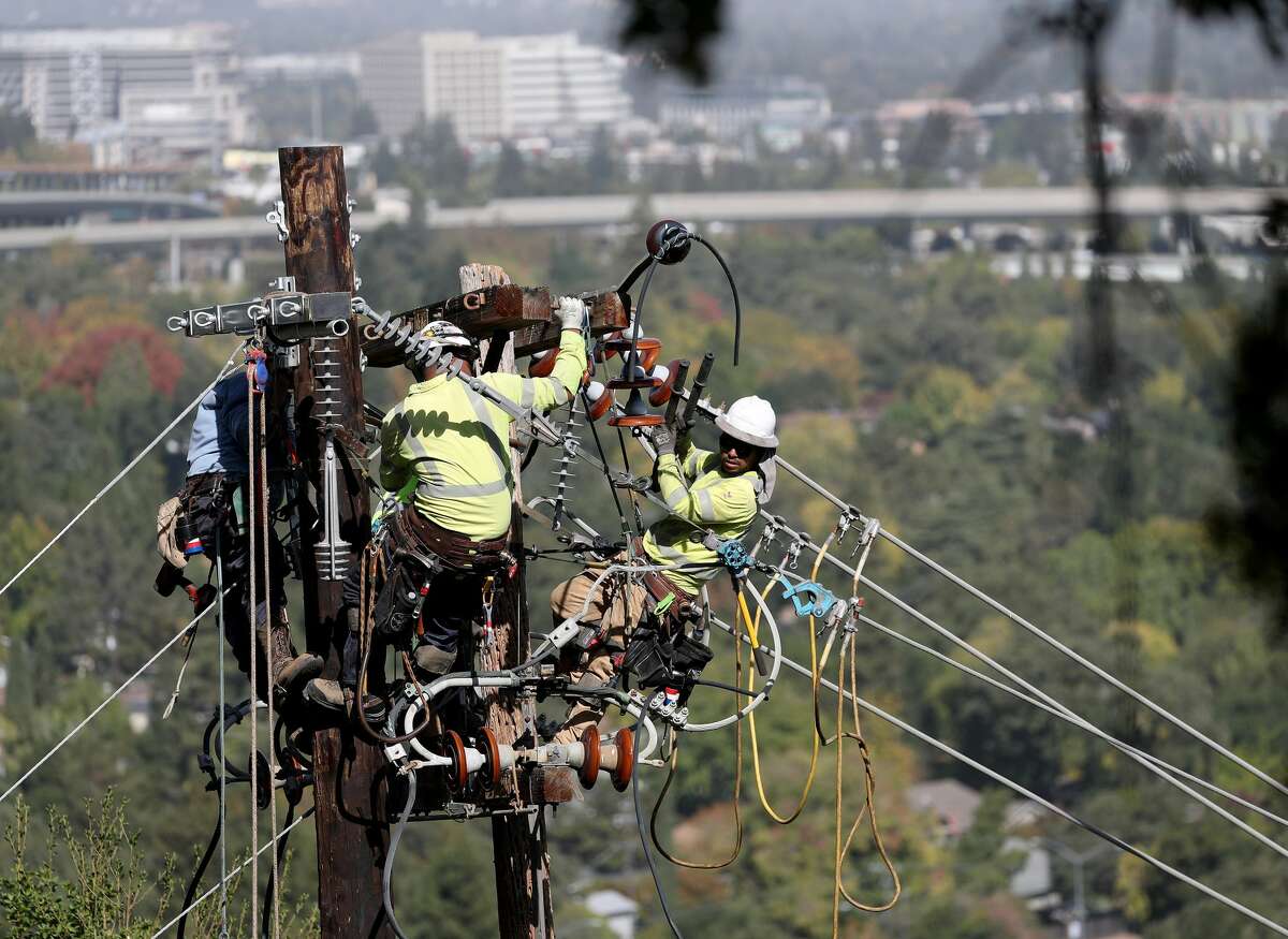 PG&E workers replace a power pole on a hillside at the Rossmoor senior community in Walnut Creek on Wednesday, Oct. 23, 2019. PG&E replaced the pole, which had been the source of several small fires, after outcry by Tim O'Keefe, chief executive officer of the Golden Rain Foundation and manager of Rossmoor.