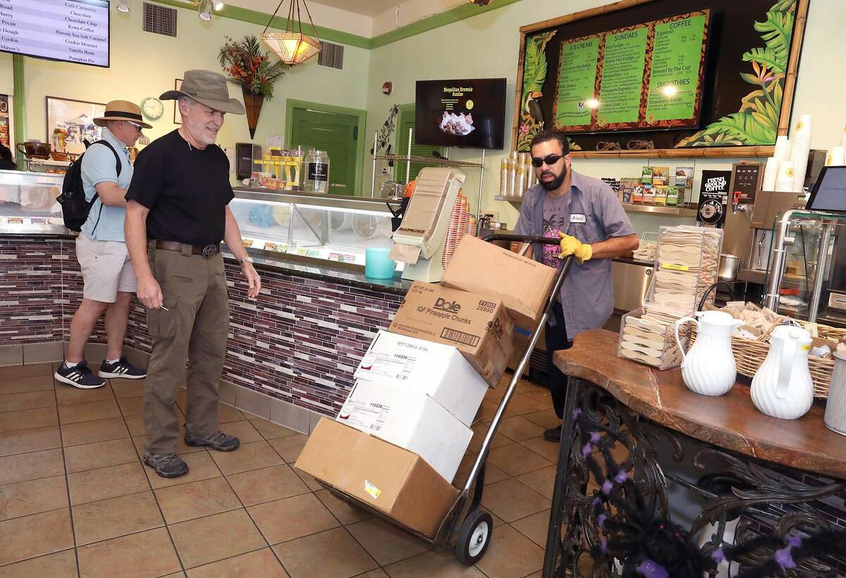 Owner Michael Lappert (left) will have to move 800 tubs of ice cream from his freezer to transport them to the Richmond location with Arturo Acosta (right) as PG&E launches the largest public safety power shut-down in Marin County on Friday, Oct. 25, 2019, in Sausalito, Calif.