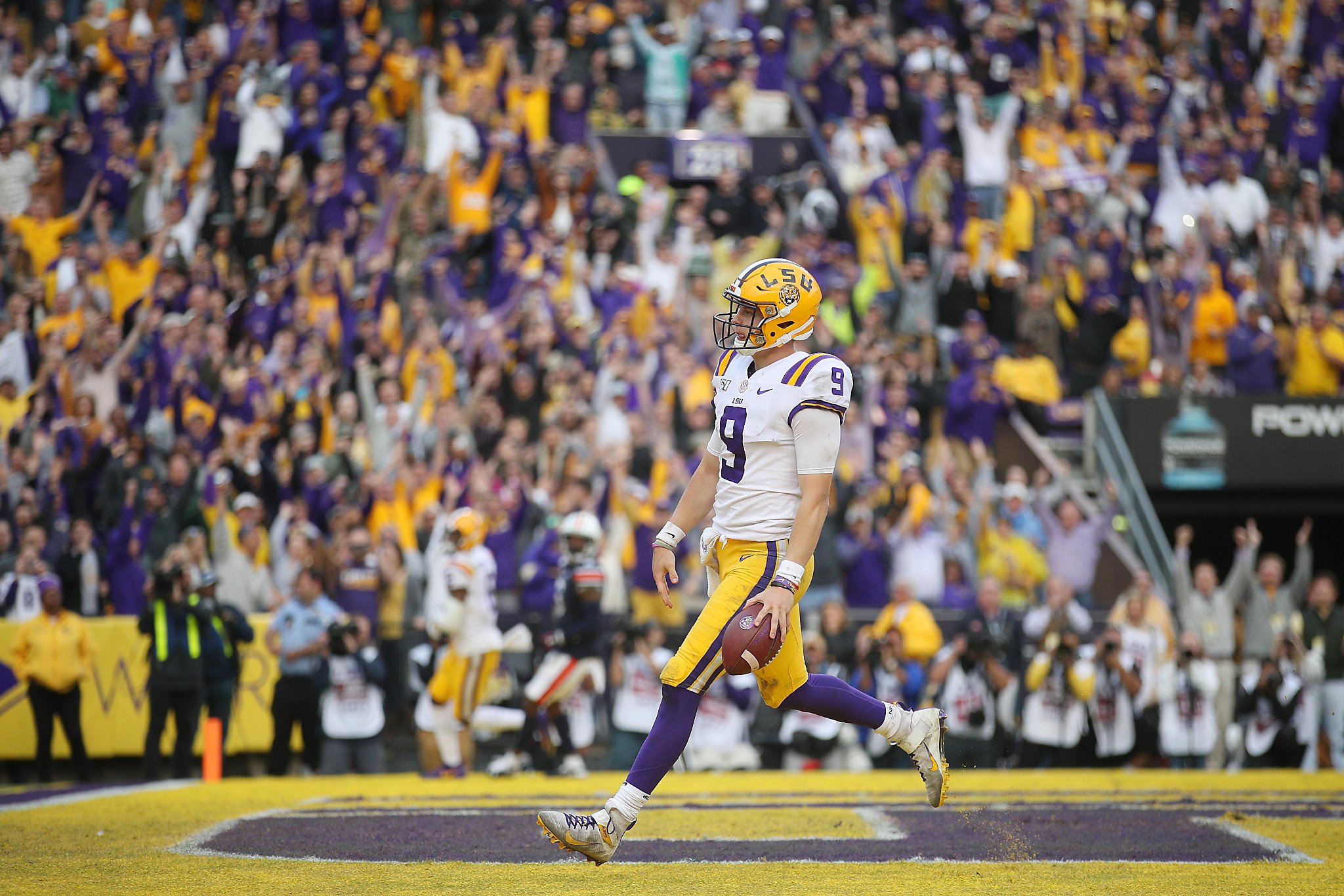 Joe Burrow LSU Tigers Unsigned White Jersey Celebrates Touchdown Photograph