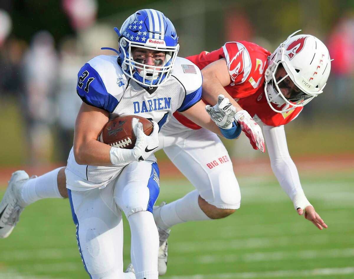 Darien’s Will Kirby (21) carries the ball in the first half against Greenwich on Oct. 26 in Greenwich. Darien won 27-21.