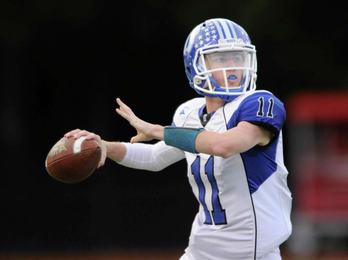 Darien’s Peter Graham looks to throw a pass against Greenwich during a regualr-season game.