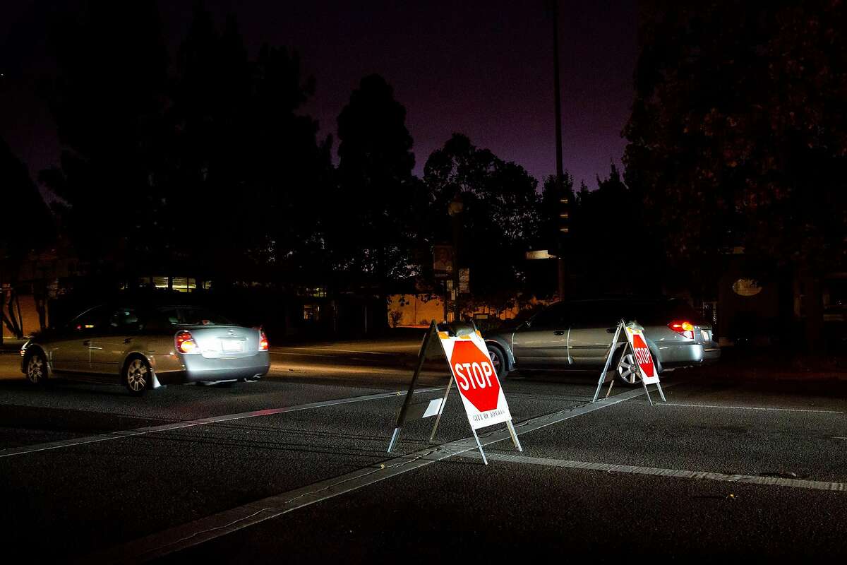 Cars drive through darkened streets in Novato, Calif. during PG&E's Marin County power shut down on Saturday, Oct. 26, 2019. Residents throughout the North Bay are expected be without power starting Saturday evening as PG&E begins it's second Public Safety Power Shut-Off. PG&E states that over 940,000 residents will be without power through the weekend.