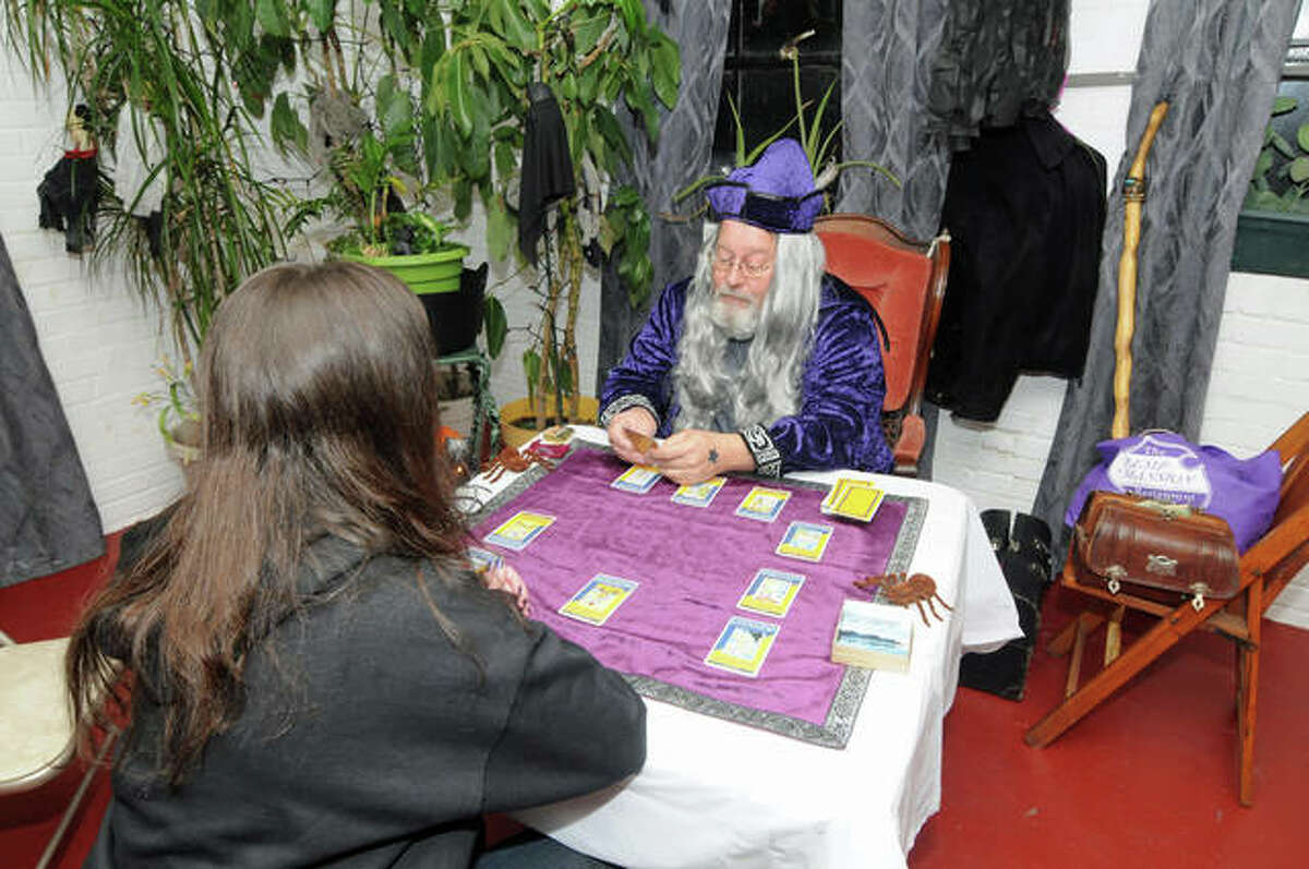 A Witches Night Out attendee gets a tarot card reading at Saturday night’s event in the old Milton School in Alton. Organizers were pleased with the turnout for the premiere event and are planning an even larger one next year.