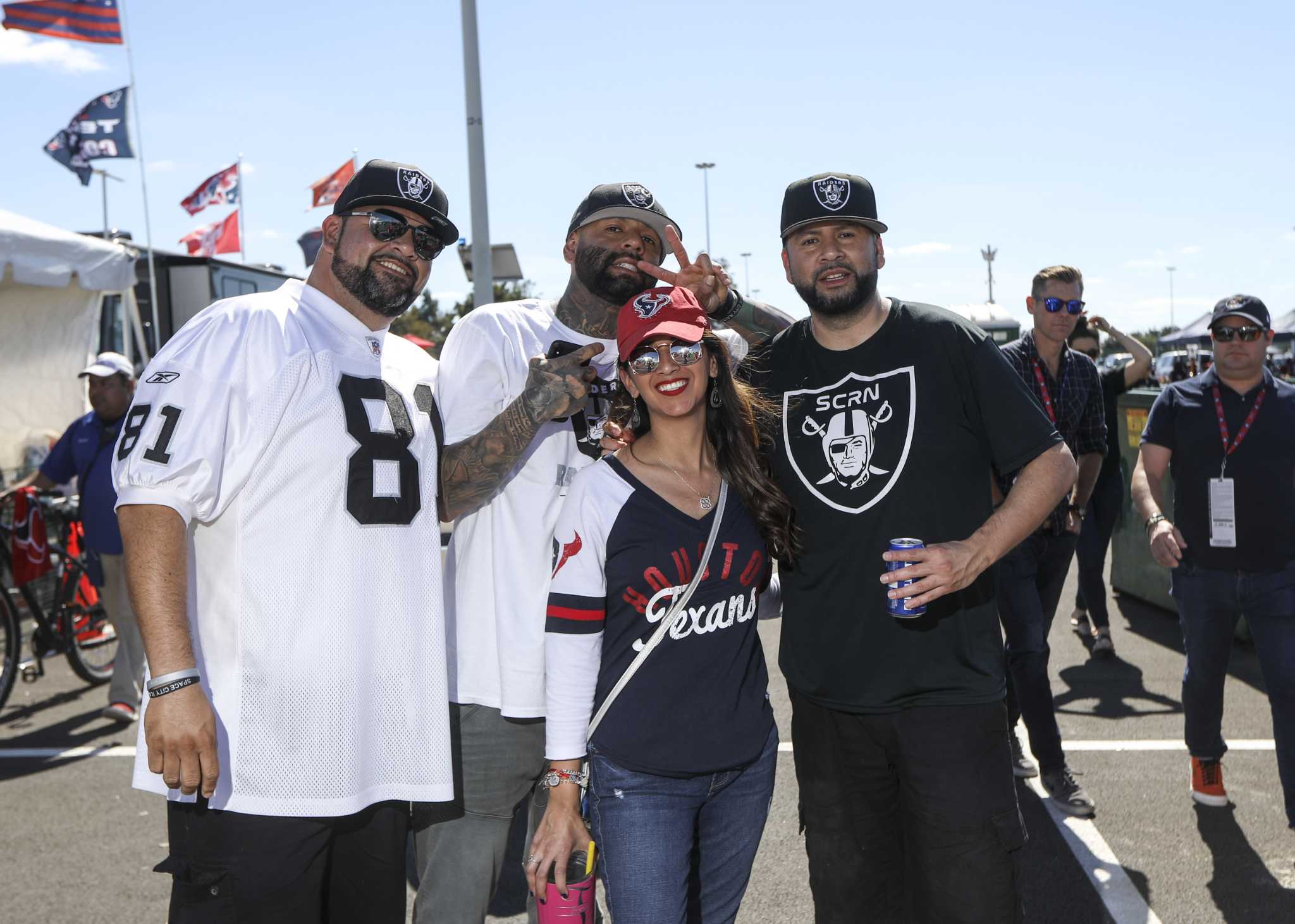 Oakland Raider fans pose during tailgating festivities before game