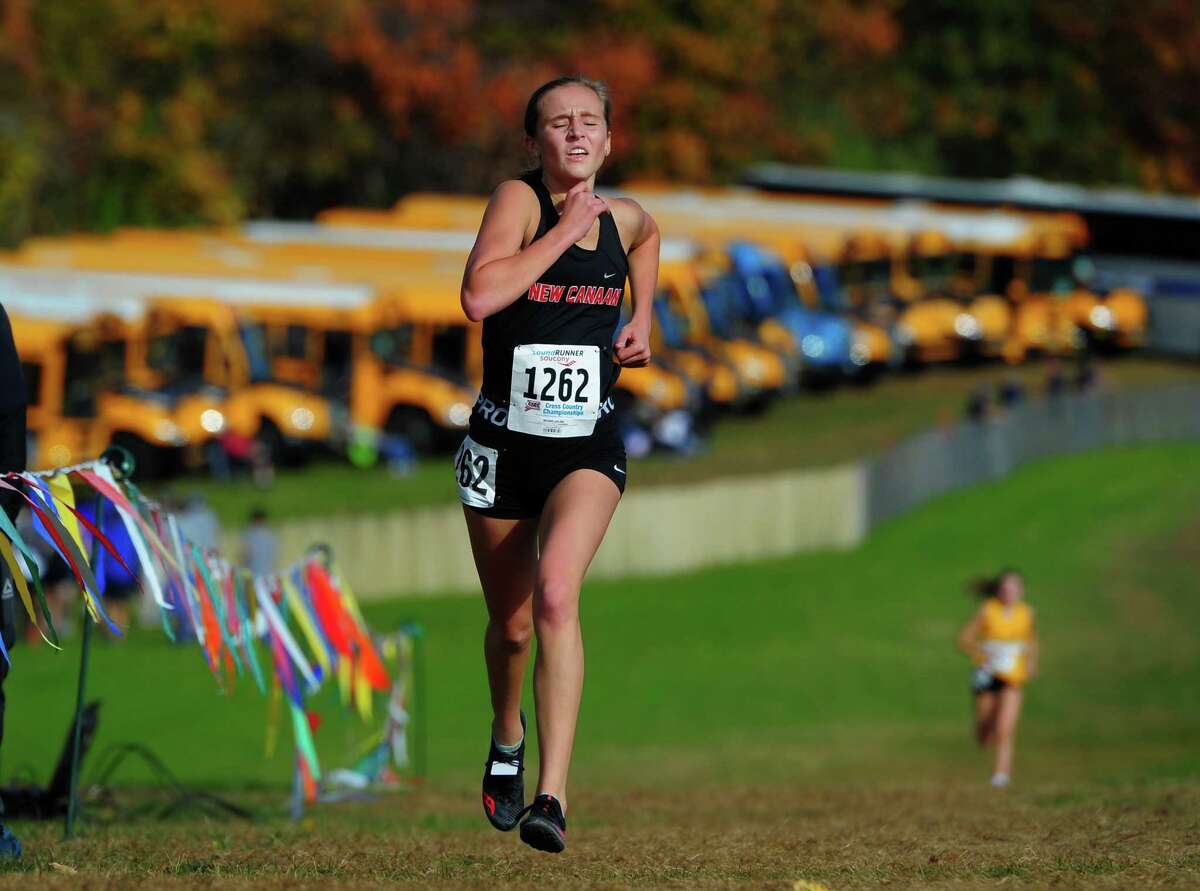New Canaan's Molly Murphy arrives at the finish line during Class L cross country championship in October. Murphy won the 3,000-meter run during last Thursday’s Wintergreen Invitational track and field meet at SCSU.