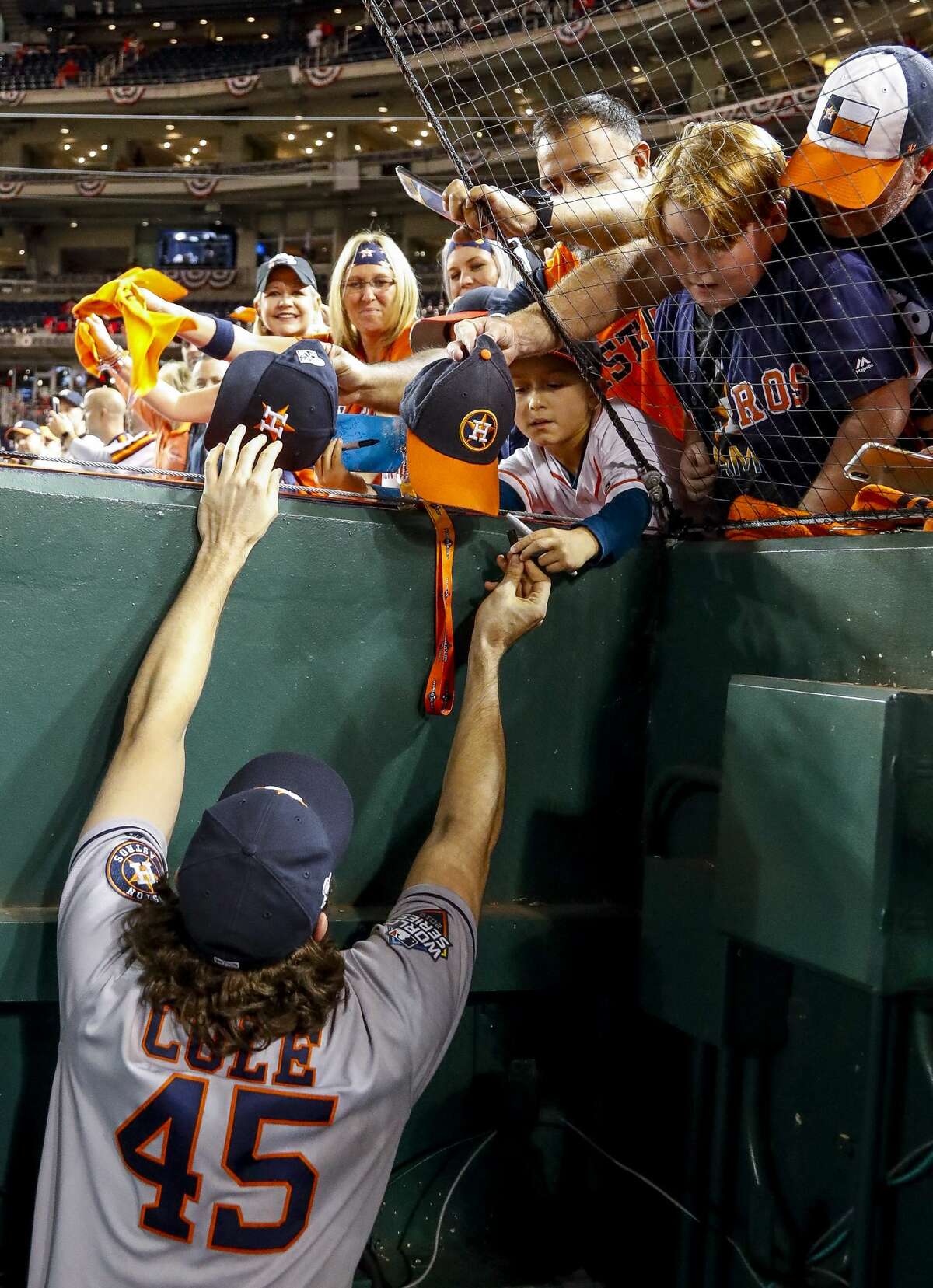 Houston Astros starting pitcher Gerrit Cole (45) signs autographs for fans after the Astros won Game 5 of the World Series 7-1 at Nationals Park in Washington, D.C. on Sunday, Oct. 27, 2019.
