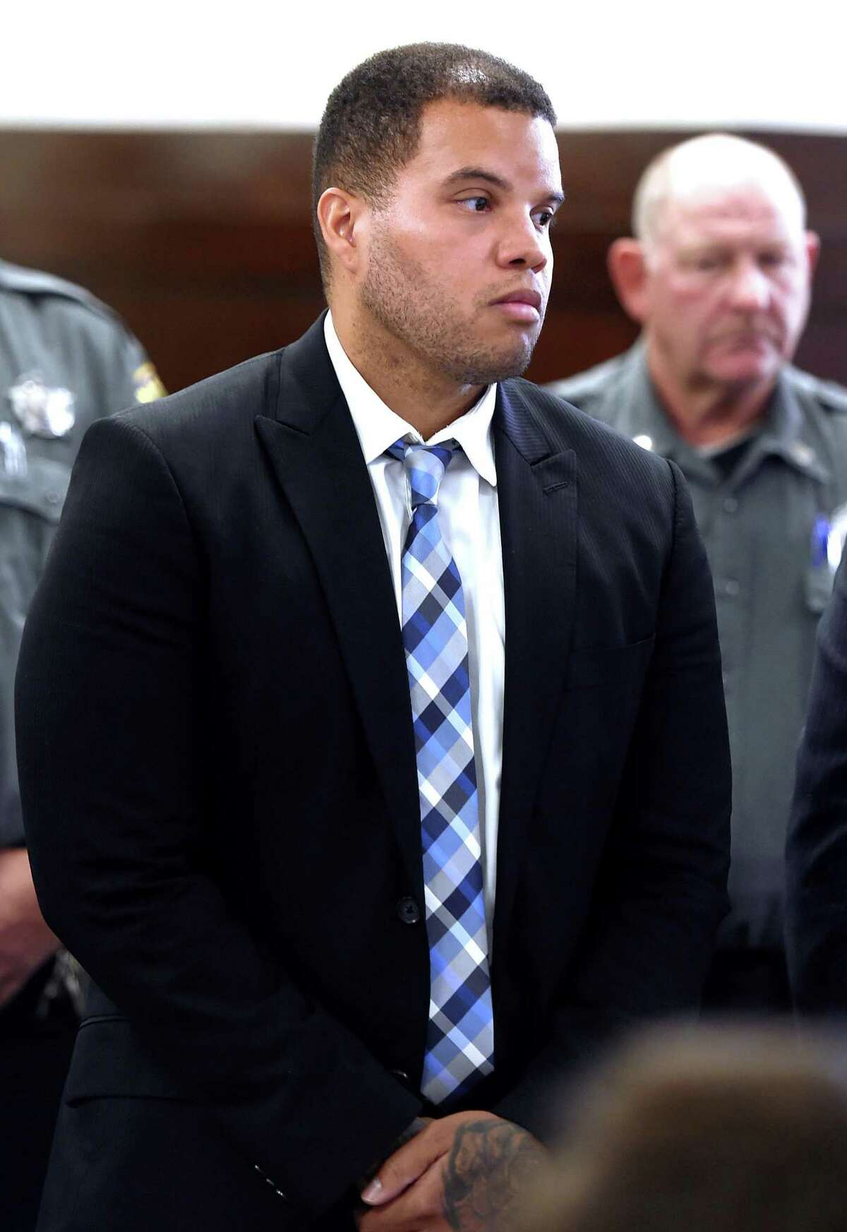 Hamden police Officer Devin Eaton is arraigned in Superior Court in New Haven Monday on charges of first- degree assault and two counts of first-degree reckless endangerment .