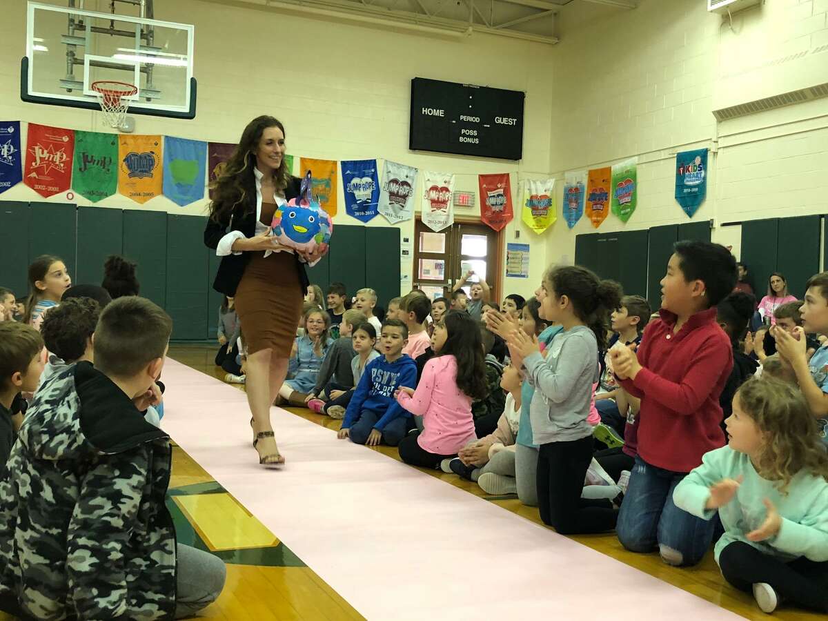 Mohegan School third grade teacher Tina Taylor shows off her class’ pumpkin.