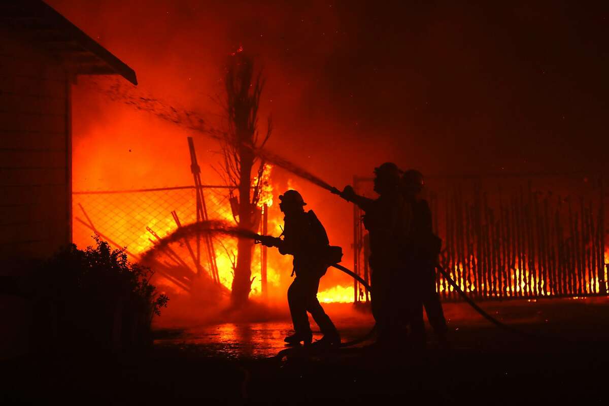 SANTA ROSA, CALIFORNIA - OCTOBER 27: Firefighters battle the Kincade Fire as it burns a barn on October 27, 2019 in Santa Rosa, California. Fueled by high winds, the Kincade Fire has burned over 30,000 acres and has prompted nearly 200,000 evacuations in Sonoma County and beyond. (Photo by Justin Sullivan/Getty Images)
