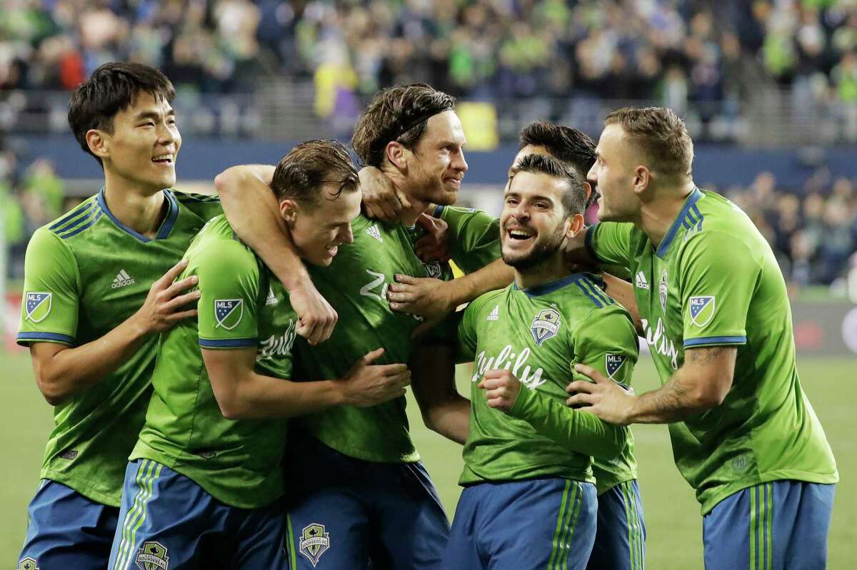 Seattle Sounders midfielder Gustav Svensson, center, celebrates with teammates after he scored a goal against Real Salt Lake during the second half of an MLS Western Conference semifinal playoff soccer match Wednesday, Oct. 23, 2019, in Seattle. The Sounders won 2-0.