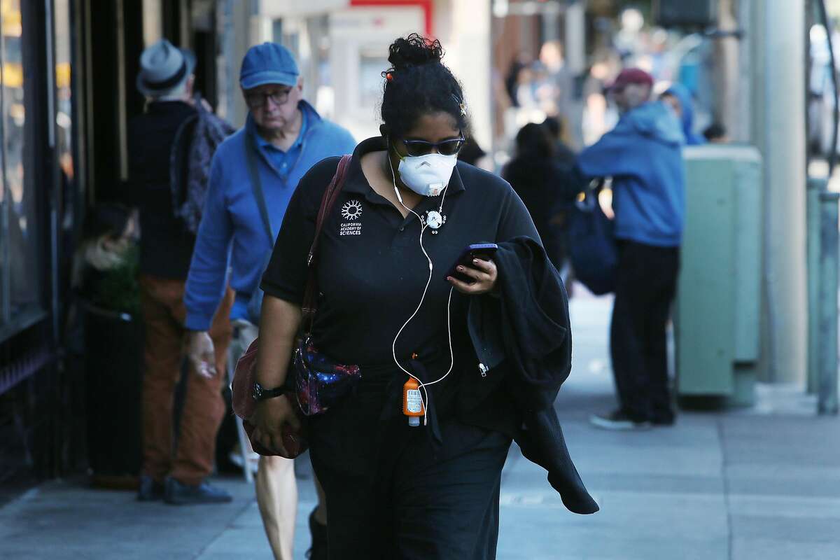 Kristina Lee, who has athsma, wears a N-95 mask as she walks on Ninth Avenue on Monday, October 28, 2019 in San Francisco, Calif. Lee says in the past poor air quality days after fires that she she suffered from light headedness and because she is at risk and recently her athsma had been acting up, is taking the extra precaution of wearing the mask.