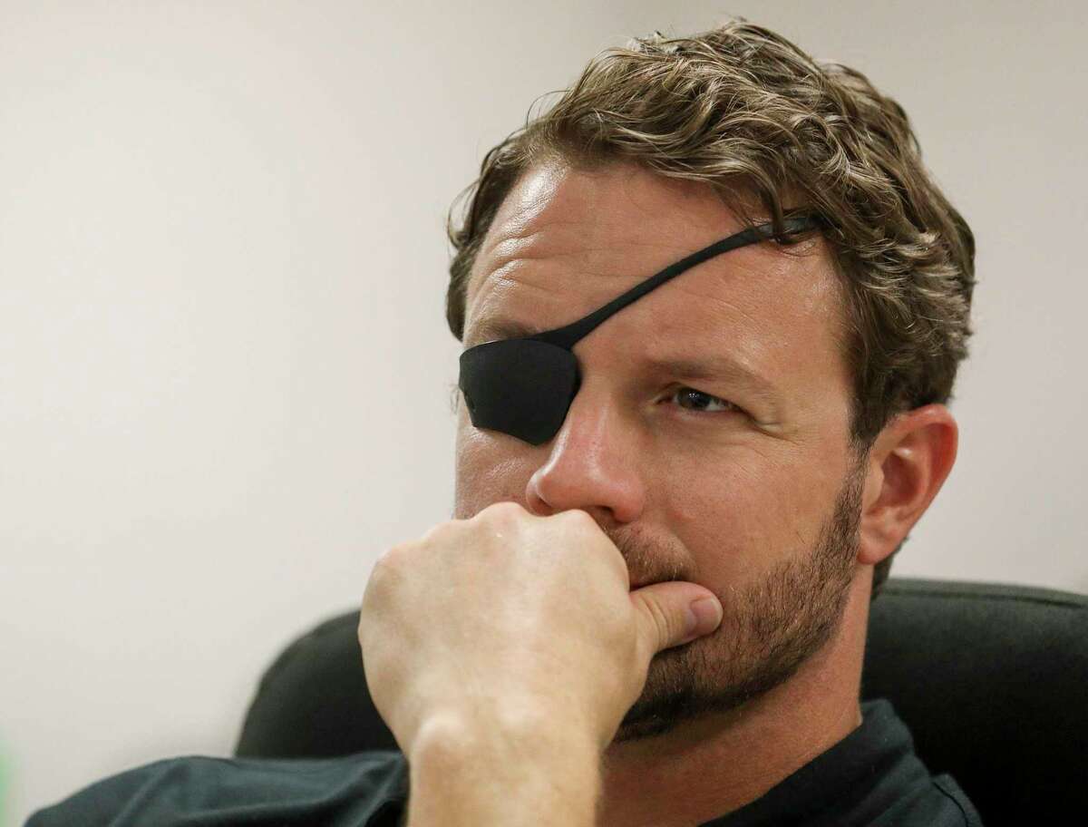 U.S. Rep. Dan Crenshaw listens to a briefing about the Addicks and Barker Reservoirs on Friday, Aug. 16, 2019, in Houston.