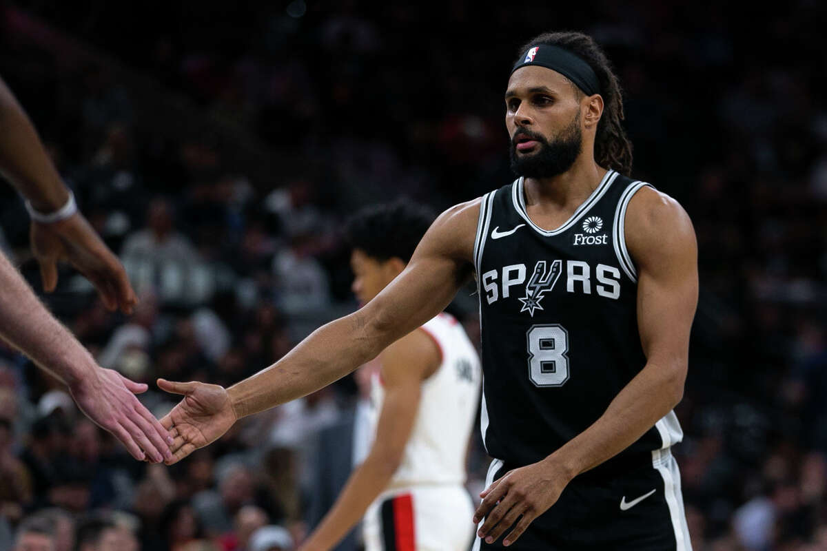San Antonio Spurs' Patty Mills claps hands with teammates before a free throw as the Spurs host the Portland Trail Blazers at AT&T Center San Antonio, Texas, on Oct. 28, 2019.