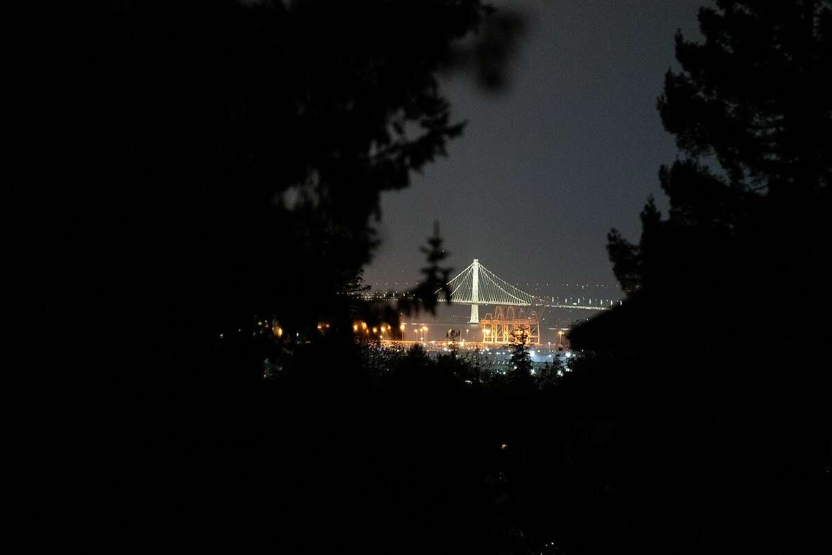 The Bay Bridge is seen in the distance from Wyngaard Avenue and Estates Drive, a neighborhood that has no power in Oakland, Calif. on Monday, Oct. 28, 2019.