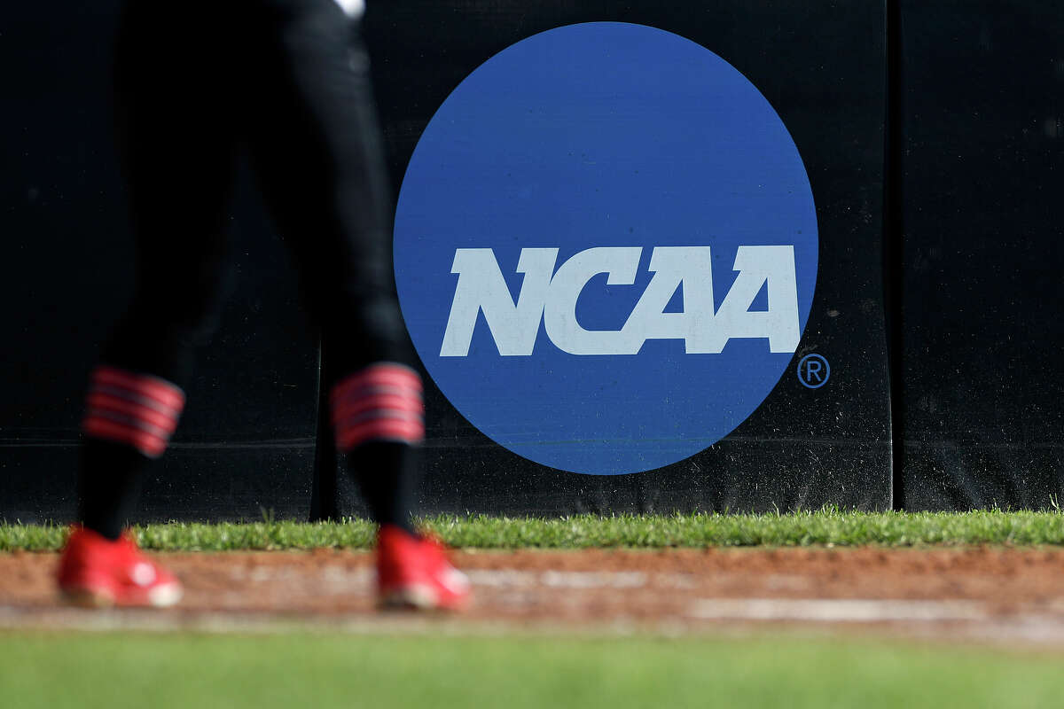 FILE - In this April 19, 2019, file photo, an athlete stands near a NCAA logo during a softball game in Beaumont, Texas.