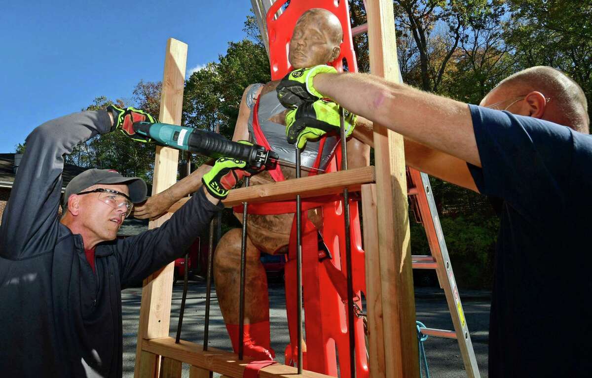 Wilton firefighters Joe Bisenius and Dan Lewis train on extricating and impaled victim during the Man Vs. Machinery course presented by PL Vulcan Fire Training Concepts on Oct.23.