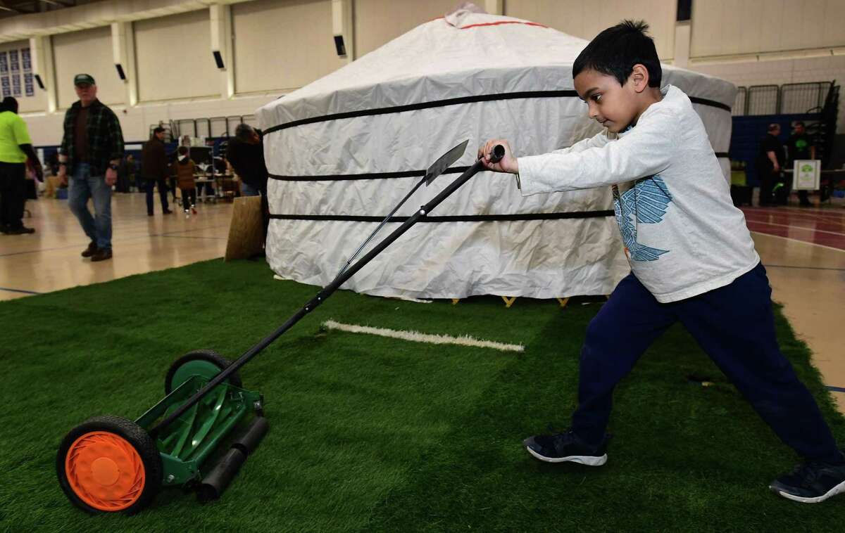 Rohan Sardana, 6, of Wilton tries out a push mower from MowGreen.com during the Wilton Go Green 2nd Annual Zero Waste Faire on Saturday, March 23, 2019, at the Wilton High School Field House.