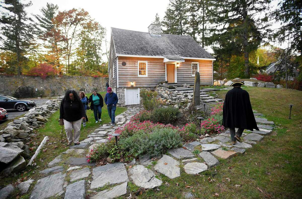 Tom Zoubek, Director of The Stamford History Center leads the tour of guests through the historic Hoyt-Barnum House in Stamford on Oct. 24, 2019. Zoubek interspersed scary stories during a presentation "Hauntings & History at Hoyt-Barnum," a tour of the oldest house in Stamford.