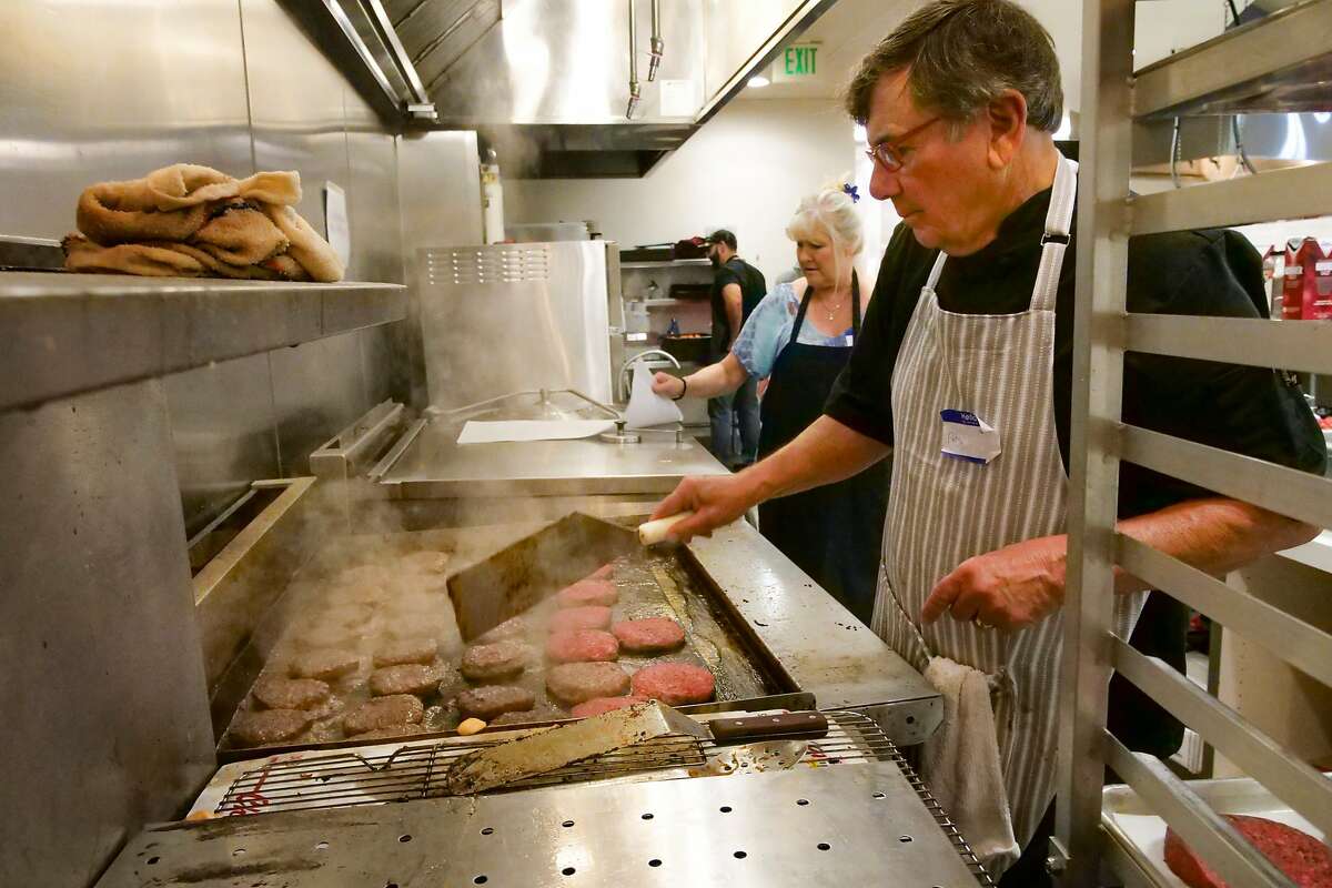 Volunteer sue chef Peter Trombetta makes burgers for the nonprofit Sonoma Family Meal as they prepare food for evacuee centers and first responders, Tuesday Oct. 29, 2019, in Petaluma, Ca.