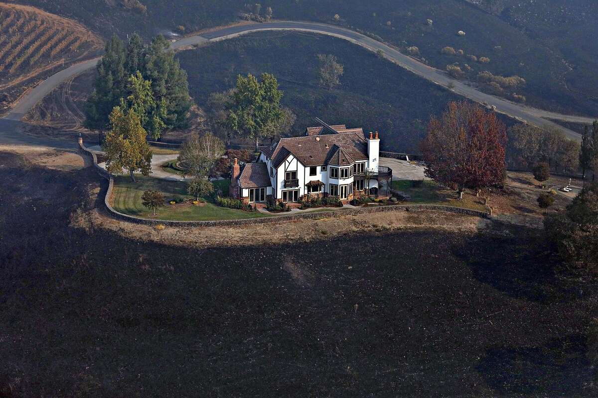 A home between Healdsburg and Windsor seen on Tuesday, Oct. 29, 2019, is surrounded by charred ground but was spared from the Kincade Fire flames.