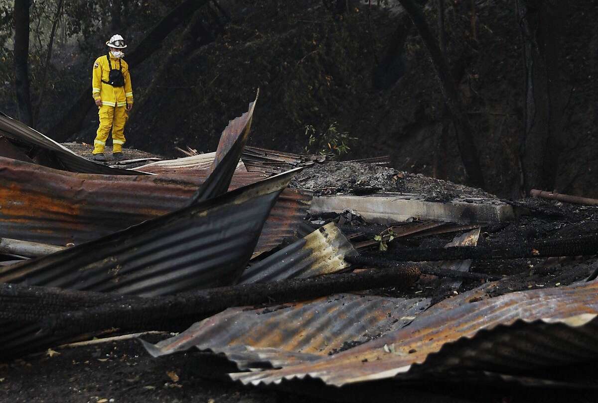 Cal Fire Damage Inspection crewmember Carlos Hernandez assesses the damage to a destroyed woodshop along Highway 128 in Healdsburg, Calif, Tuesday, October 10, 2019 after a handful of buildings were destroyed on Hank Wetzel�s peoperty by the Kincade Fire.
