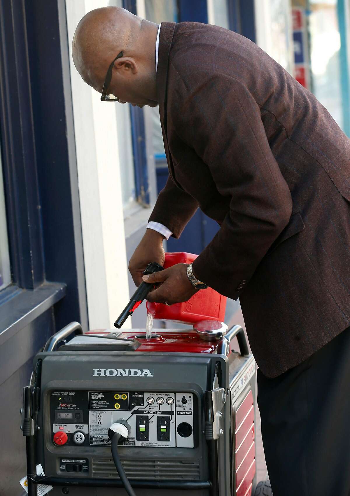 Capital City Pharmacy owner Arthur Metu fills a rented portable generator with gasoline on Georgia Street as the public safety power shutoff issued by PG&E continues for a third consecutive day in Vallejo, Calif. on Tuesday, Oct. 29, 2019. Metu had to drive all the way to Livermore to pick up the generator, the closest location he could find.