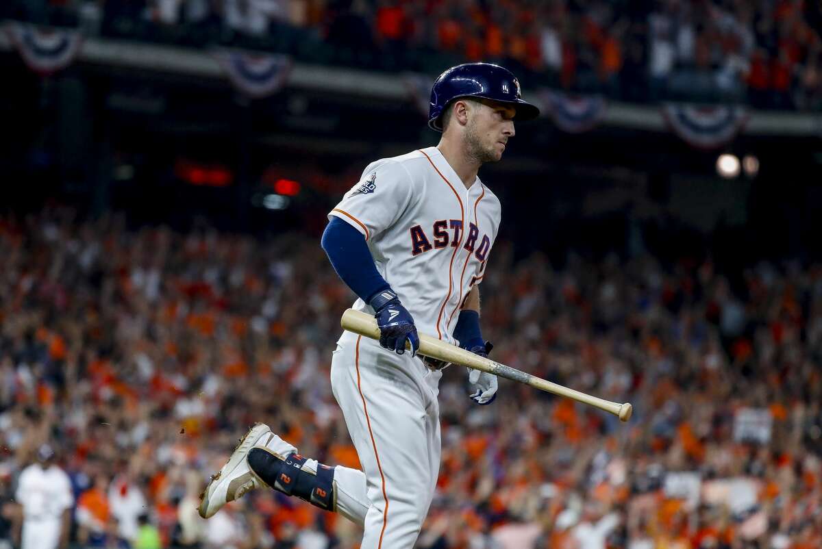 Houston Astros third baseman Alex Bregman (2) holds onto his bat as he runs to first after hitting a solo home run to give the Astros a 2-1 lead during the first inning of Game 6 of the World Series at Minute Maid Park on Tuesday, Oct. 29, 2019, in Houston.