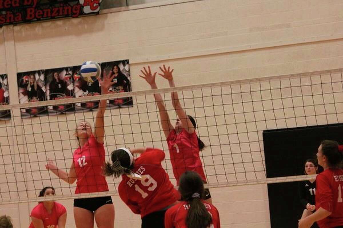 Alison Duddles (12) and Demi Lodholtz go up for the ball against Benzie Central on Thursday. (Herald Review photo/John Raffel)