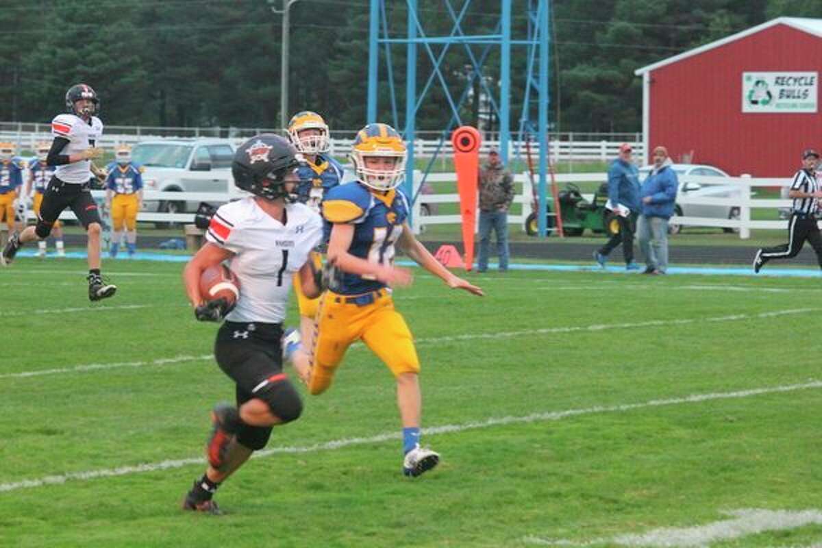 Danny Witbeck (12) gives chase to a Manton player during the season. (Herald Review file photo)