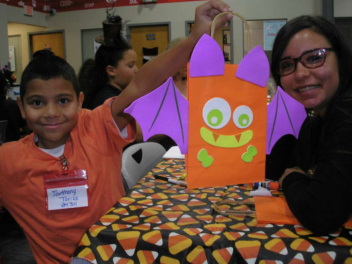 Shelton resident Denisse Ramos, right, is a mentor in the "Beyond School Walls" mentoring program at her company, Comcast in Berlin. The 11-year-old program is sponsored by Comcast and managed by Nutmeg Big Brothers Big Sisters. At a recent mentoring session, Ramos and her mentee, Janthony, celebrated Halloween with holiday-related snacks, games and trick or treating at Comcast's Berlin headquarters. Janthony and 24 other students from New Britain's Lincoln Elementary School are mentees in "Beyond School Walls."