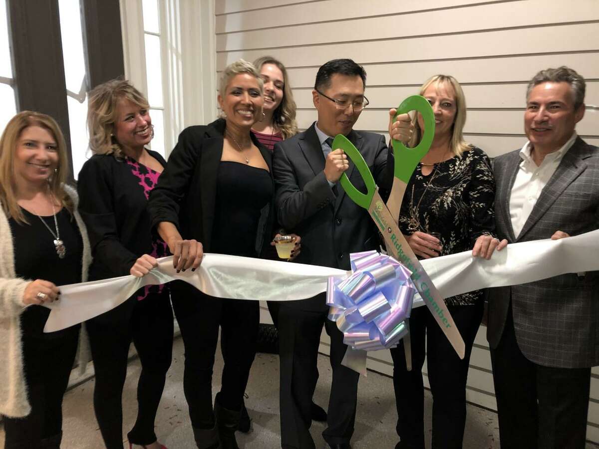 At the ribbon cutting for Tooth Fairy Pediatric Dentistry & Orthodontics and Next Gen Dental are, from left, Teresa Coelho, Dr. Megan Lovell, Joanna Rodriguez, Jenn Banks, Dr. Suho Lee, Melissa Grant, Dr. Joseph Sciarrino and Dr. Christopher Silver.