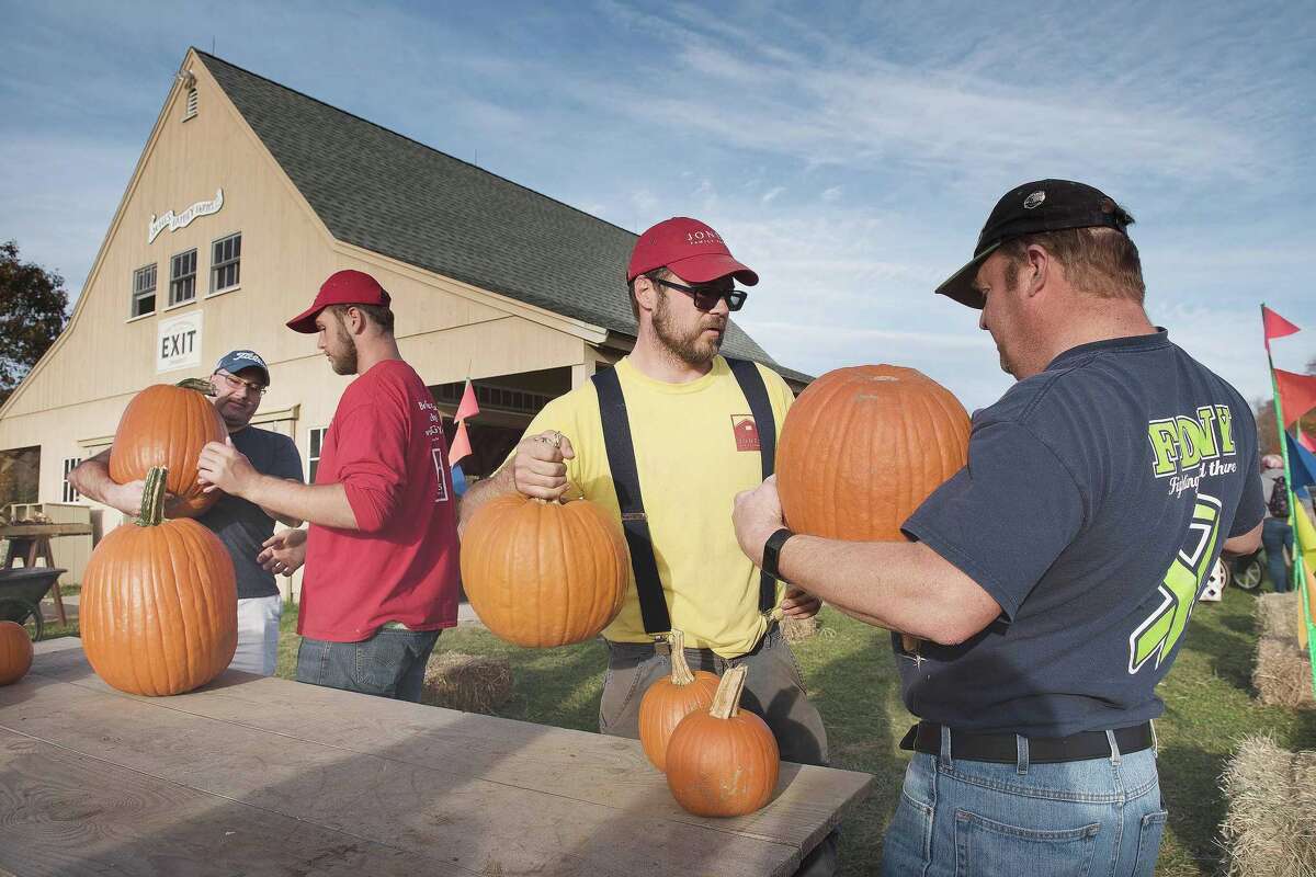 Alex Voytek of Jones Family Farms helps weigh pumpkins on Saturday, Oct. 26, 2019 at its Children's Festival for UNICEF and an initiative for breast cancer awareness. Funds from the event will be shared with both UNICEF and the Valley Goes Pink program. Alex Voytek of Jones Family Farms helps weigh pumpkins on Saturday, Oct. 26, 2019 at its Children’s Festival for UNICEF and an initiative for breast cancer awareness. Funds from the event will be shared with both UNICEF and the Valley Goes Pink program.