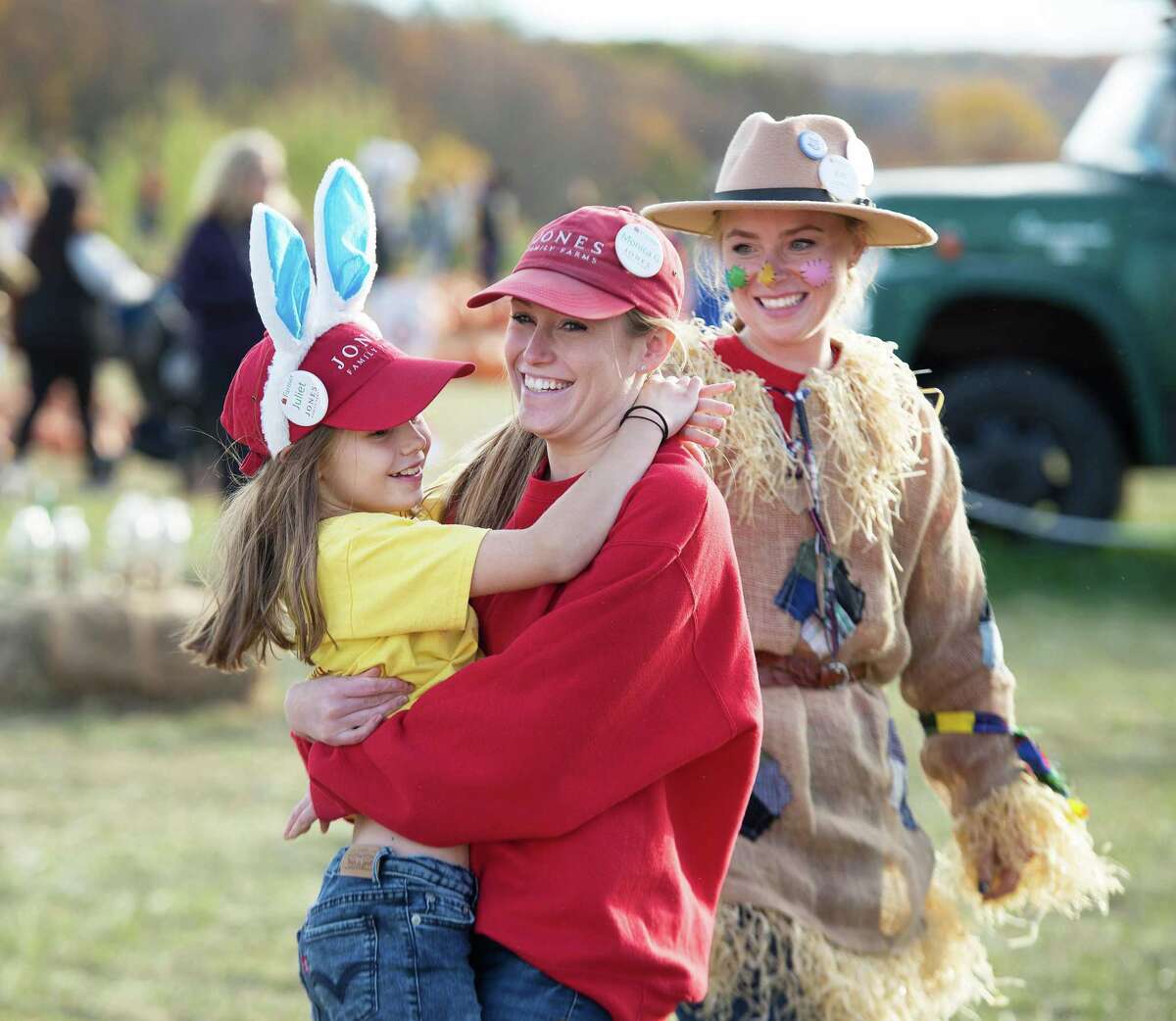 Juliet Jones hugs Monica Gorton while Kat Hollyday looks on.