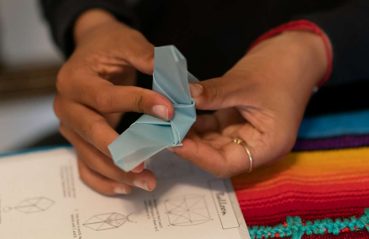 Kaia Marbin, 11, making origami butterflies to represent immigrant children being held at border camps on Sunday, Oct. 13, 2019, in Alameda City, Calif.