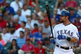 ARLINGTON, TX - AUGUST 03: Josh Hamilton #32 of the Texas Rangers wears Franklin batting gloves as he bats during a game against the Houston Astros at Globe Life Park in Arlington on August 3, 2015 in Arlington, Texas. The Texas Rangers defeated the Houston Astros 12-9. (Photo by Sarah Crabill/Getty Images)