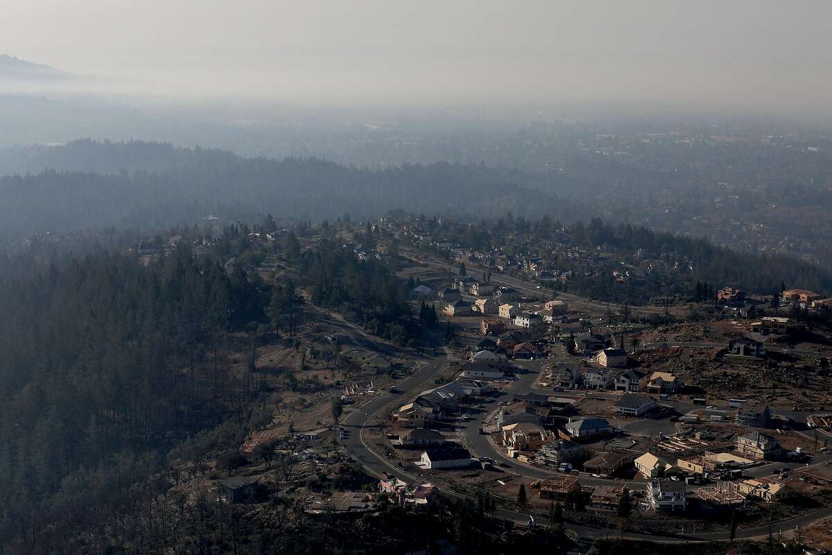 Fountaingrove homes, which were hit by the Tubbs Fire in 2017, are seen amidst smoke from the Kincade Fire on Tuesday, Oct. 29, 2019.