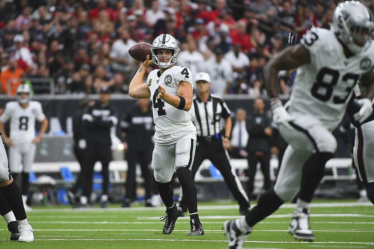 Oakland Raiders quarterback Derek Carr (4) looks at a replay where he fell  over his own offensive lineman during the first half of their NFL game in  Santa Clara, Calif., Thursday, Nov.