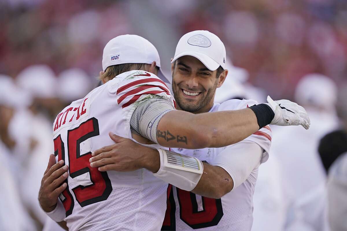 San Francisco 49ers quarterback Jimmy Garoppolo embraces tight end George Kittle at the end of an NFL football game against the Carolina Panthers in Santa Clara, Calif., Sunday, Oct. 27, 2019. San Francisco won the game 51-13. (AP Photo/Tony Avelar)