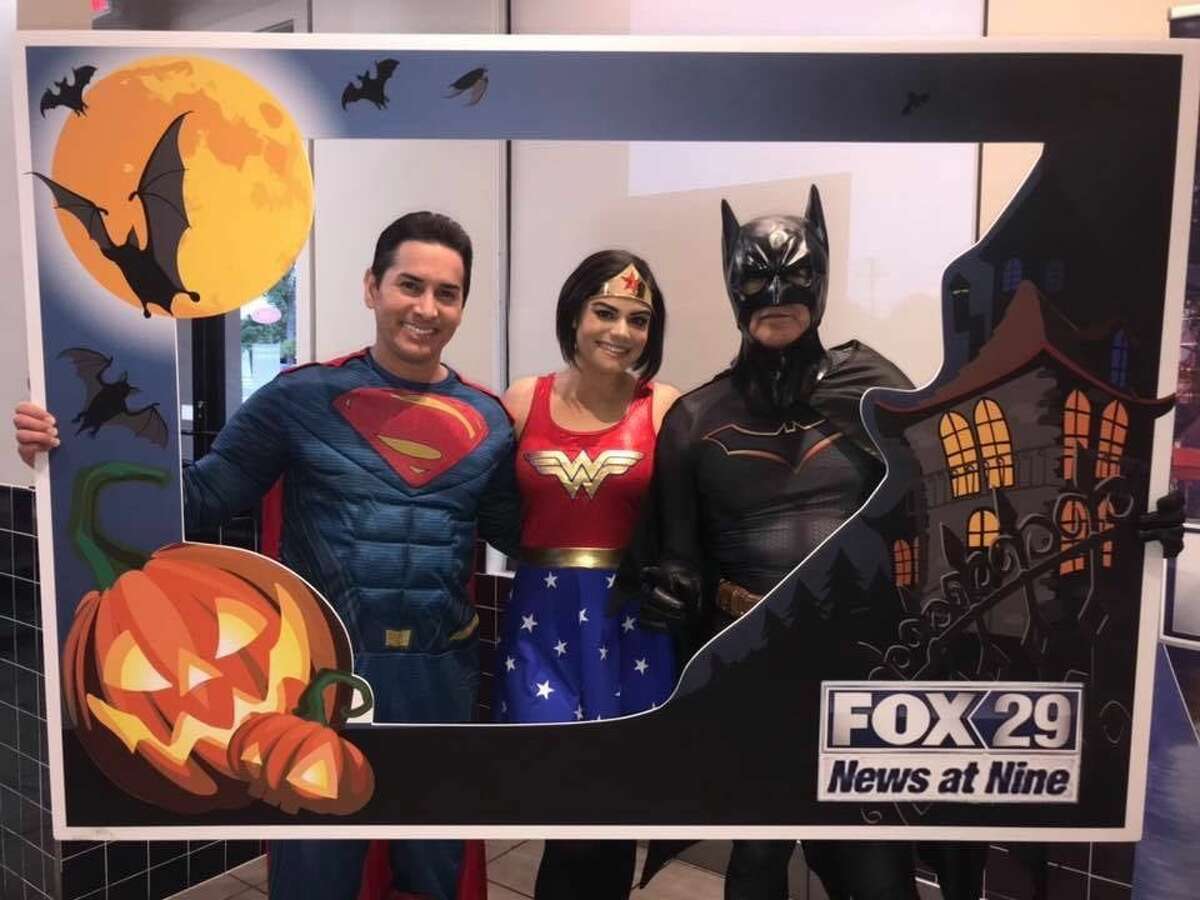 "Fox News at Nine" anchors Ryan Wolf as Superman, Camilla Rambaldi as Wonder Woman and Chief Meteorologist Alex Garcia as Batman.