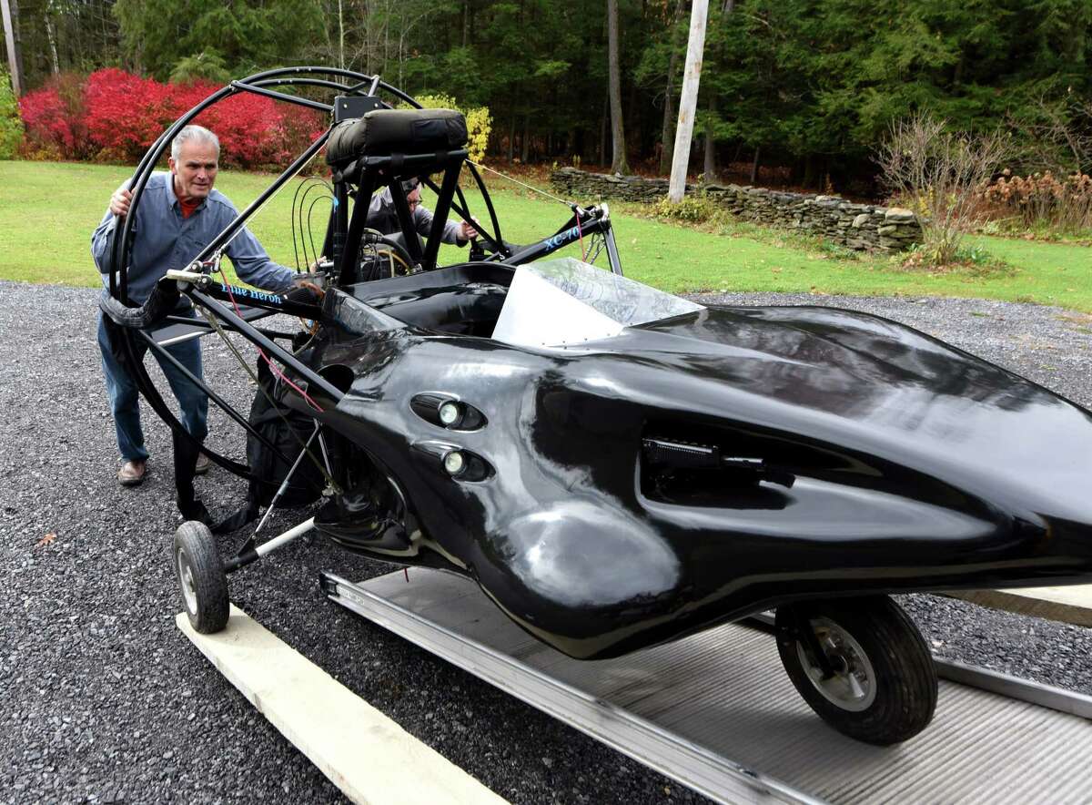 Nick Viscio, left, helps Dan Treado, assistant curator from the International Spy Museum, load a "villainous Parahawk" from the James Bond film "The World is Not Enough," which is owned by Viscio on Thursday, Oct. 31, 2019, in Knox, N.Y. Treado is taking the former movie prop to D.C., where it will be displayed in the museum. (Will Waldron/Times Union)