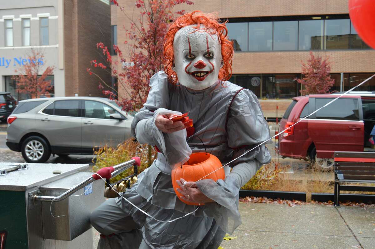 "Pennywise" paid downtown Midland a visit for Halloween today, handing out candy to unsuspecting victims and suspiciously riding a Great Lakes Loon cart. (Ashley Schafer/Ashley.Schafer@hearstnp.com)