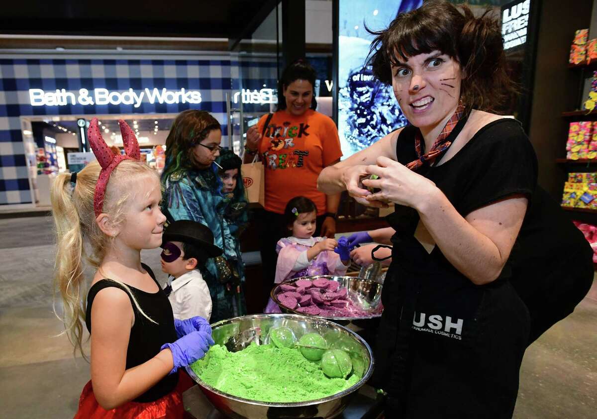 Penny White, 7 of Norwalk, makes a bath bomb with Lush Shop Manager Amy Merli as children trick-or-treat at The SoNo Collection during the new mall's Malloween event Thursday, October 31, 2019, in Norwalk, Conn. Retailers offered candy and crafts for costumed revelers.
