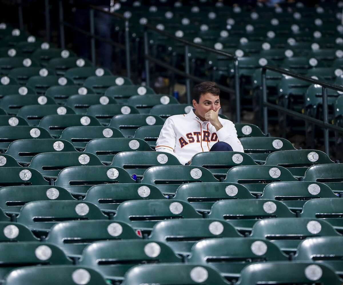 An Astros fan sits in the stands after the Astros lost Game 7 of the World Series at Minute Maid Park on Wednesday, Oct. 30, 2019, in Houston.