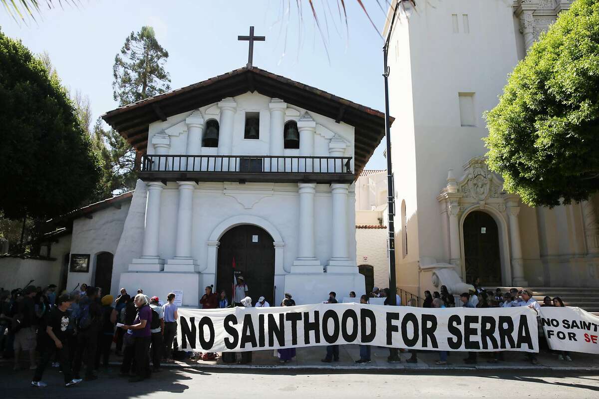 Demonstrators gather in front of Mission Dolores as they protest the canonization of Junipero Serra on Wednesday, September 23, 2015 in San Francisco, Calif.