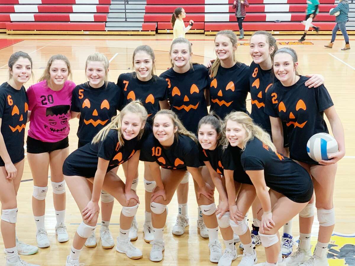 The Onekama Portagers pose in their festive Halloween uniforms after capping the regular season with a sweep of Hart.