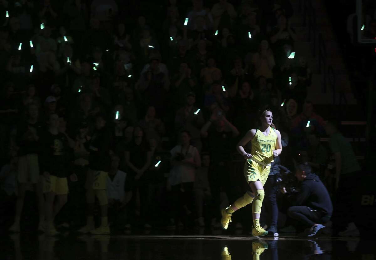 Oregon's Sabrina Ionescu takes the court as Duck fans wave glowing flashlights before an NCAA college women's basketball game against Arizona State Friday, Jan 18, 2019, in Eugene, Ore. (AP Photo/Chris Pietsch)