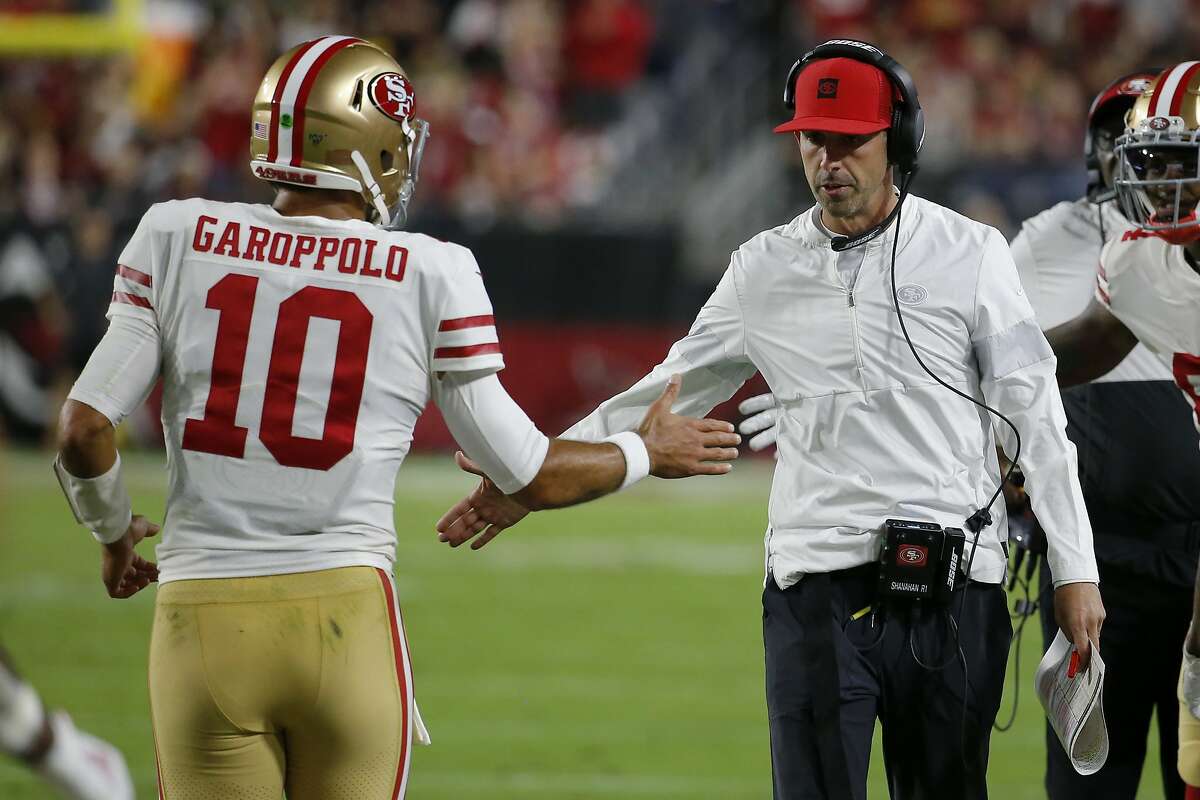 San Francisco 49ers quarterback Jimmy Garoppolo (10) greets San Francisco 49ers head coach Kyle Shanahan after a touchdown against the Arizona Cardinals during the first half of an NFL football game, Thursday, Oct. 31, 2019, in Glendale, Ariz. (AP Photo/Rick Scuteri)