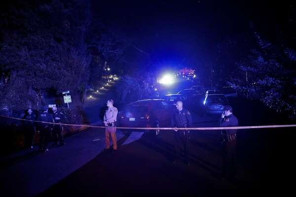 Contra Costa County Sheriffs deputies stand watch at a barricade at the intersection of Knickerbocker Lane and Spring Road near the location where several people were shot at a Halloween party on Lucille Way in Orinda.
