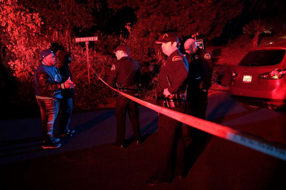 Two men whose cars had been caught up behind the police tape ask Contra Costa Sheriffs deputies if they can retrieve their cars at the intersection of Knickerbocker Lane and Spring Road near the location where several people were shot at a Halloween party on Lucille Way in Orinda , Calif., on Friday, November 1, 2019. Early reports stated that 4 people had been killed with others injured and transported to nearby hospitals. Though several of the injuries were believed to have been caused when guests ran from the shooting.