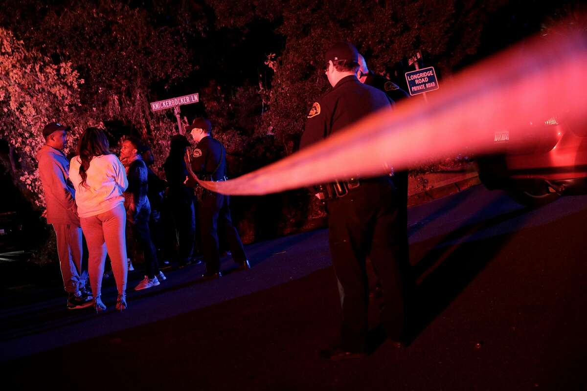 A group of people whose cars had been caugh up behind the police tape ask Contra Costa Sheriffs deputies if they can retrieve their cars at the intersection of Knickerbocker Lane and Spring Road near the location where several people were shot at a Halloween party on Lucille Way in Orinda , Calif., on Friday, November 1, 2019. Early reports stated that 4 people had been killed with others injured and transported to nearby hospitals. Though several of the injuries were believed to have been caused when guests ran from the shooting.